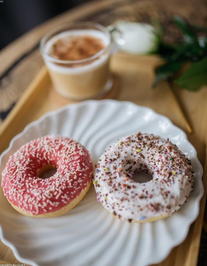 Latte and doughnuts on a serving tray